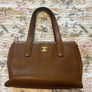 CHANEL brown tote with gold hardware.
